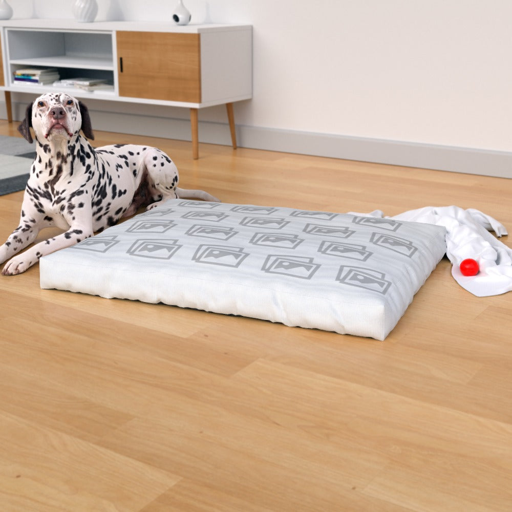 Custom waterproof dog bed placed on a wooden floor, surrounded by pet toys and accessories for lifestyle appeal with dog next to it and template photo design mock up