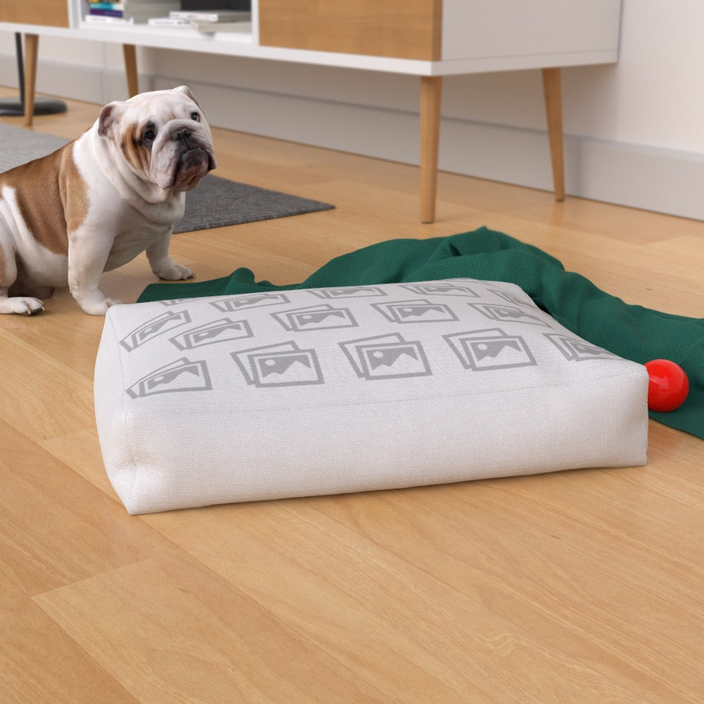 Custom waterproof dog bed placed on a wooden floor, surrounded by pet toys and dog accessories for lifestyle appeal.