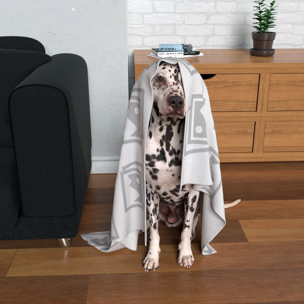Personalised pet blanket displayed on a over Dalmatian dog, featuring a custom design and company logo for branding.