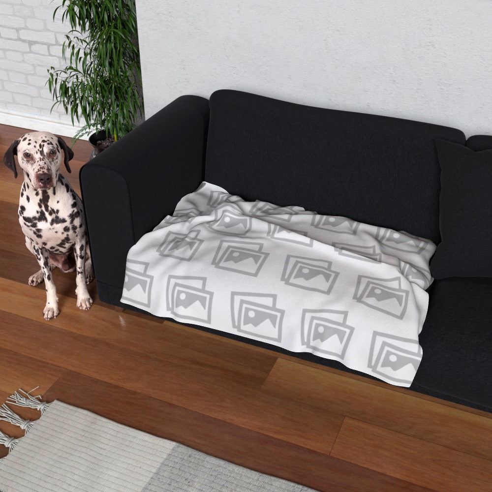 Custom pet blanket laid out on a sofa, highlighting its size, softness, and personalised print area